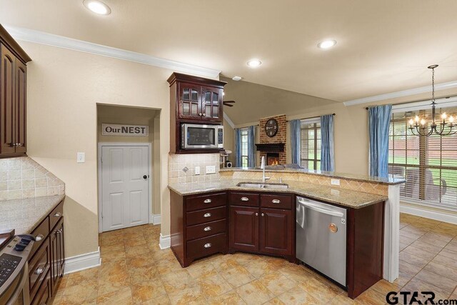 803 Marquette Ln, Tyler, TX 75703 - kitchen featuring stainless steel appliances, a sink, a chandelier, a peninsula, and backsplash