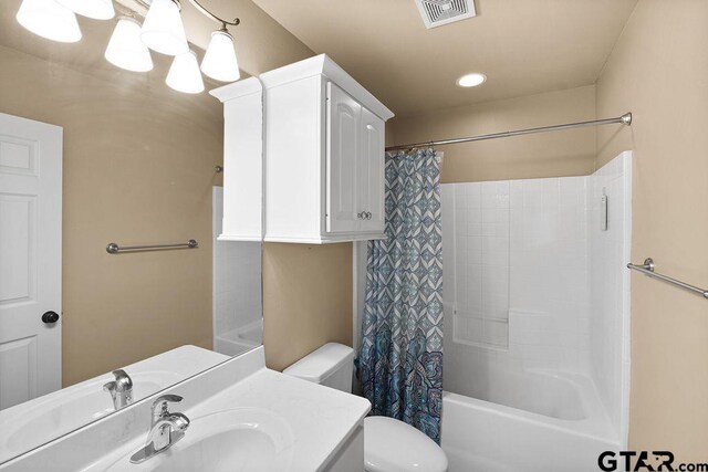803 Marquette Ln, Tyler, TX 75703 - bathroom with toilet, shower / bath combination with curtain, vanity, and recessed lighting