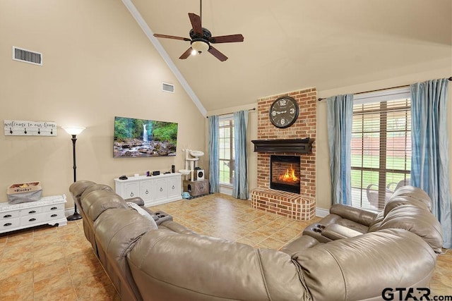 803 Marquette Ln, Tyler, TX 75703 - tiled living area featuring a ceiling fan, a fireplace, high vaulted ceiling, ornamental molding, and baseboards