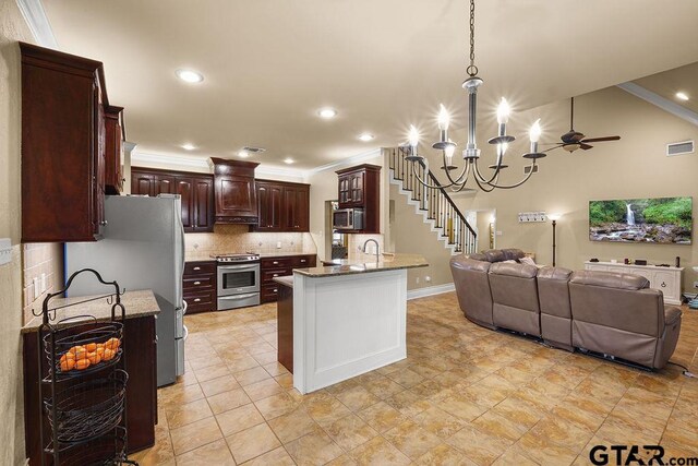 803 Marquette Ln, Tyler, TX 75703 - kitchen featuring appliances with stainless steel finishes, open floor plan, dark brown cabinets, ornamental molding, and tasteful backsplash