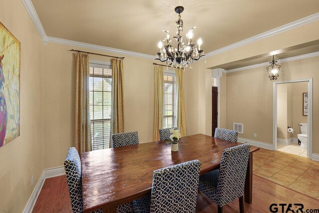 803 Marquette Ln, Tyler, TX 75703 - dining room with a chandelier, crown molding, and baseboards