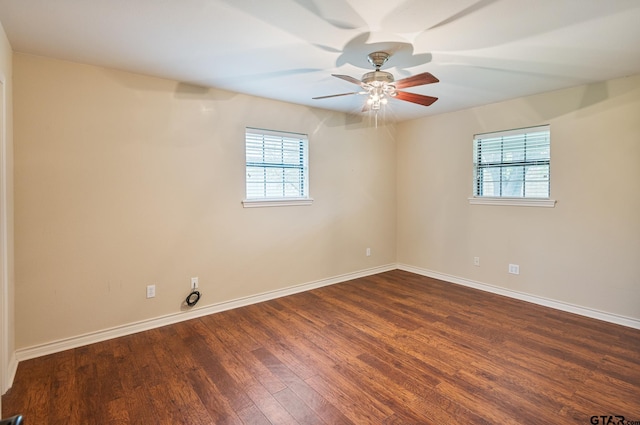 spare room with ceiling fan, a healthy amount of sunlight, and dark hardwood / wood-style flooring