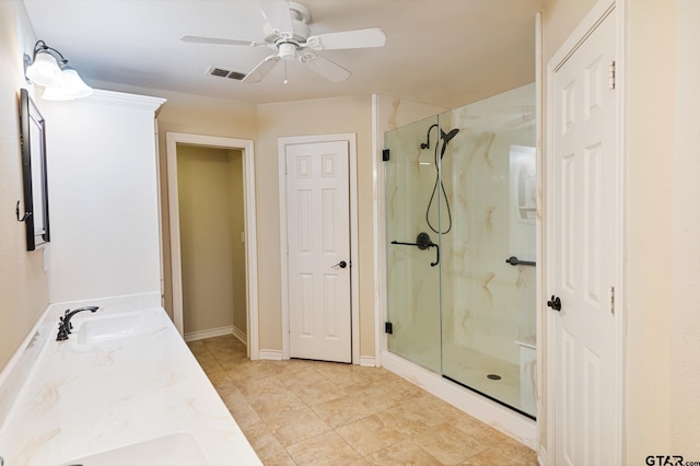 bathroom featuring walk in shower, ceiling fan, vanity, and tile patterned floors