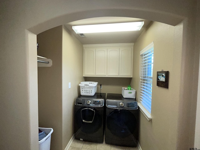 214 Rosebrook Cir, Whitehouse, TX 75791 - laundry area with washing machine and dryer, arched walkways, light tile patterned flooring, and cabinet space