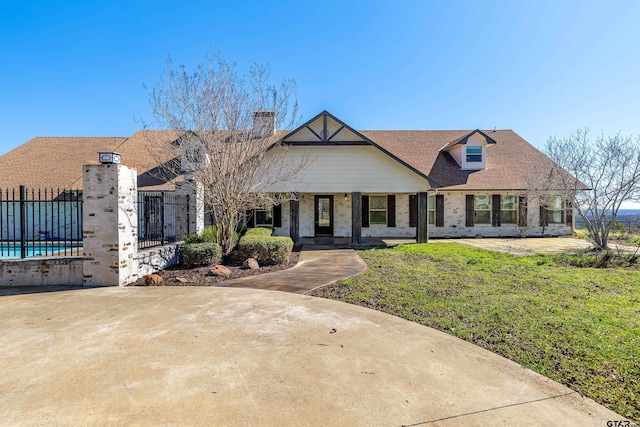 view of front of home featuring a front yard and a pool