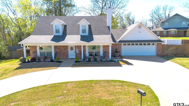 2505 W Gay Ave, Gladewater, TX 75647 - view of front of home featuring concrete driveway, brick siding, an attached garage, and covered porch