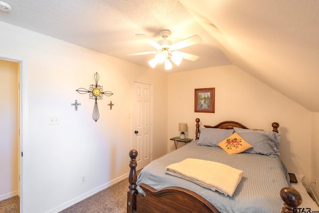 2505 W Gay Ave, Gladewater, TX 75647 - carpeted bedroom with lofted ceiling, ceiling fan, a textured ceiling, and baseboards