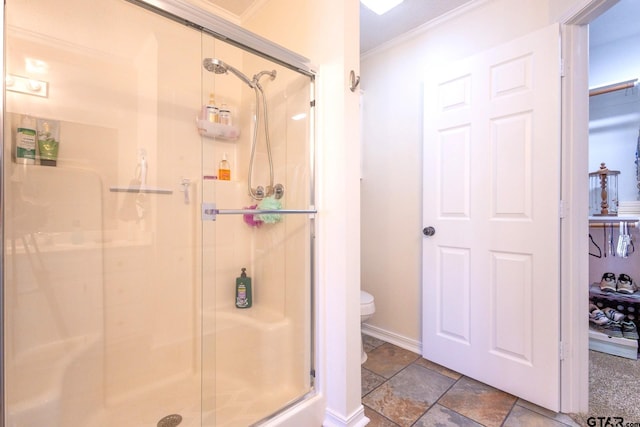 2505 W Gay Ave, Gladewater, TX 75647 - full bathroom with crown molding, a shower stall, stone tile flooring, toilet, and baseboards
