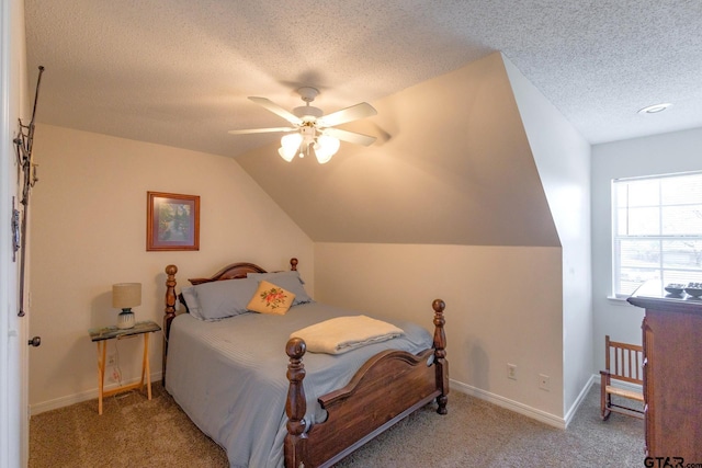 2505 W Gay Ave, Gladewater, TX 75647 - bedroom with a textured ceiling, carpet, vaulted ceiling, baseboards, and a ceiling fan