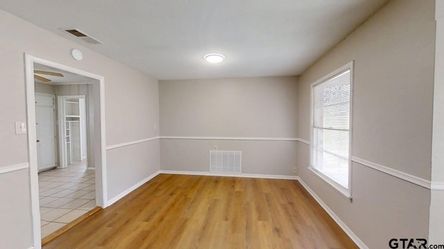 unfurnished room with baseboards, visible vents, and light tile patterned floors