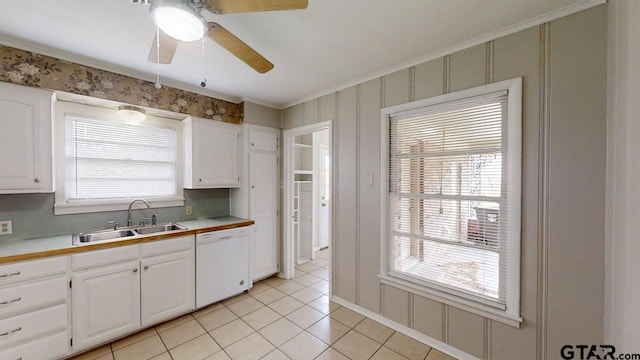 kitchen featuring dishwasher, a ceiling fan, a sink, and white cabinetry