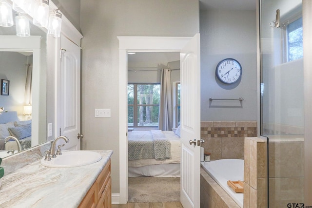 bathroom featuring plus walk in shower and vanity