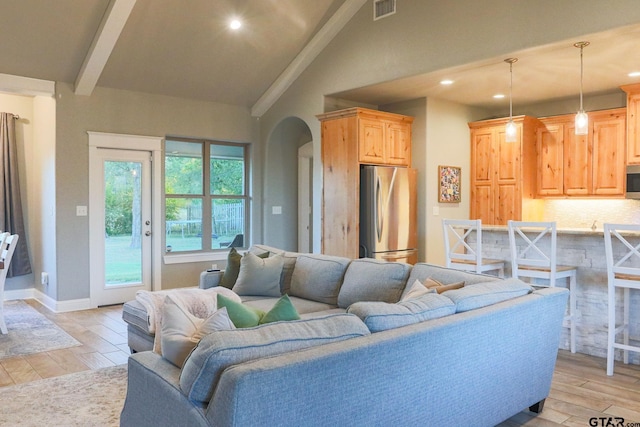 living room featuring vaulted ceiling with beams