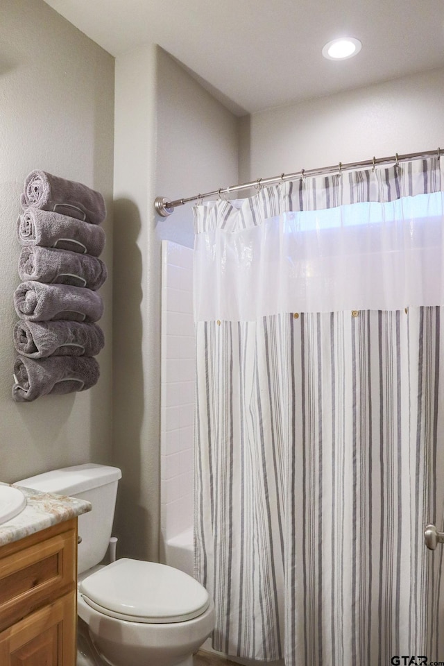 full bathroom featuring vanity, toilet, and shower / tub combo with curtain