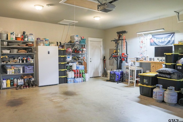 garage with white fridge and a garage door opener