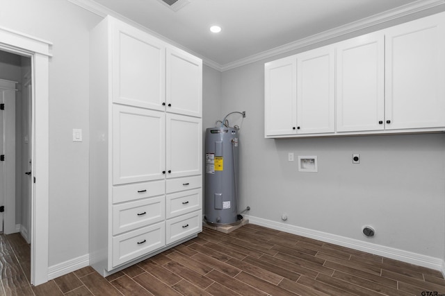 clothes washing area featuring cabinets, ornamental molding, electric dryer hookup, electric water heater, and dark hardwood / wood-style flooring