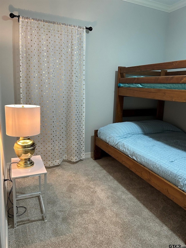 bedroom featuring carpet flooring and crown molding