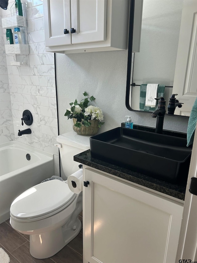 full bathroom featuring vanity, toilet, and tiled shower / bath combo