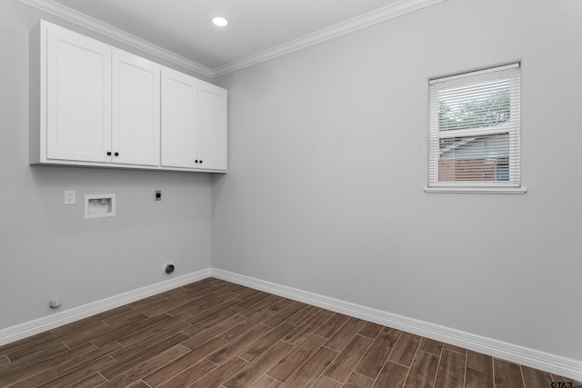 laundry area with ornamental molding, hookup for a washing machine, cabinets, dark wood-type flooring, and electric dryer hookup