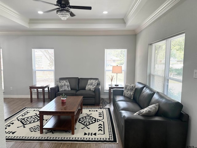 living room with a wealth of natural light, wood-type flooring, and crown molding