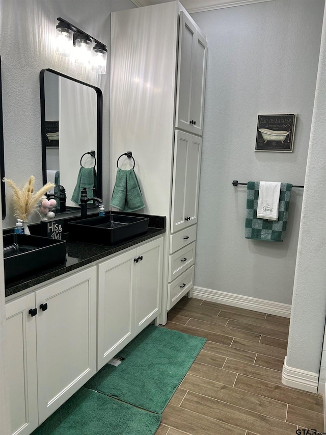 bathroom with vanity and hardwood / wood-style flooring