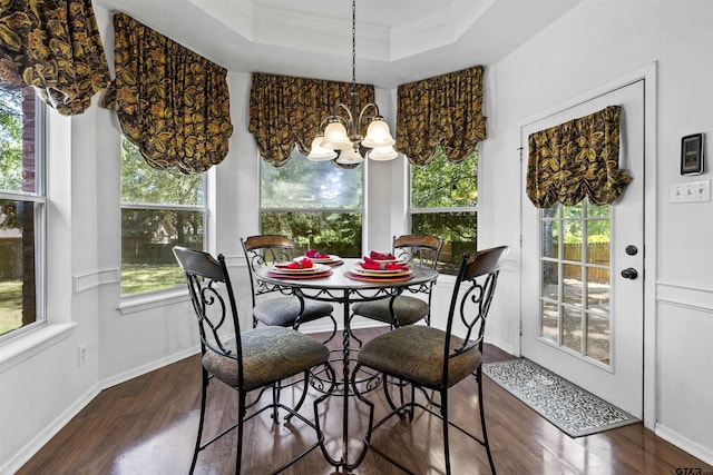 1737 Bearwood Ln, Tyler, TX 75703 - dining room featuring a raised ceiling, dark wood-style flooring, ornamental molding, a chandelier, and baseboards