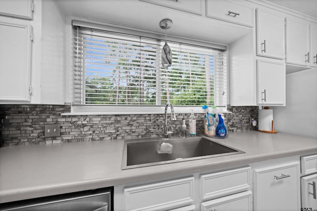 kitchen featuring sink, hanging light fixtures, decorative backsplash, and white cabinets