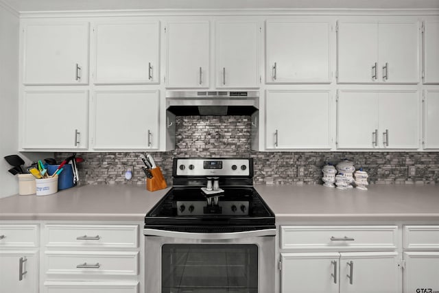 kitchen with stainless steel electric stove, white cabinetry, and backsplash