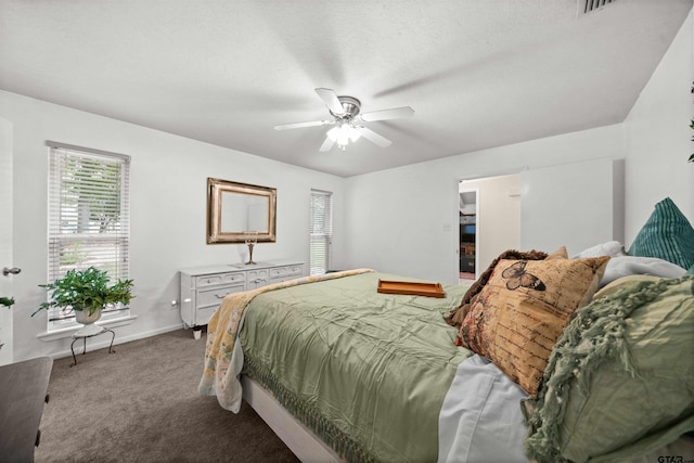 carpeted bedroom with ceiling fan and a textured ceiling