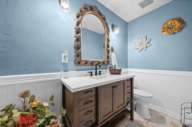 bathroom with vanity, toilet, and vaulted ceiling