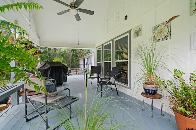 wooden deck featuring area for grilling and ceiling fan