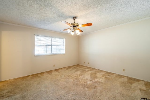 empty room with a textured ceiling, carpet floors, a ceiling fan, and crown molding