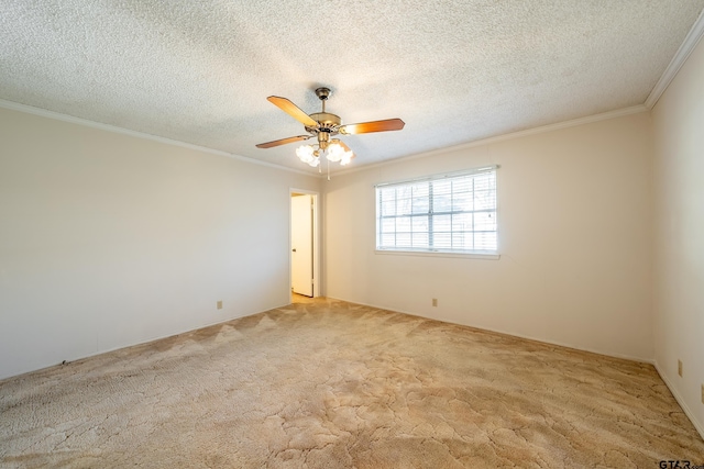 carpeted empty room featuring ornamental molding, a textured ceiling, and a ceiling fan