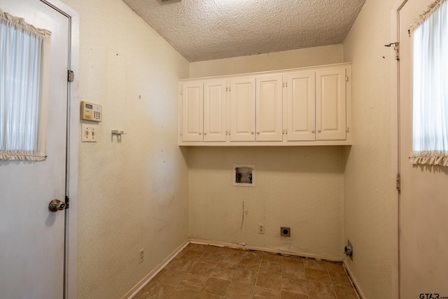 laundry area featuring cabinet space, a textured ceiling, washer hookup, and hookup for an electric dryer