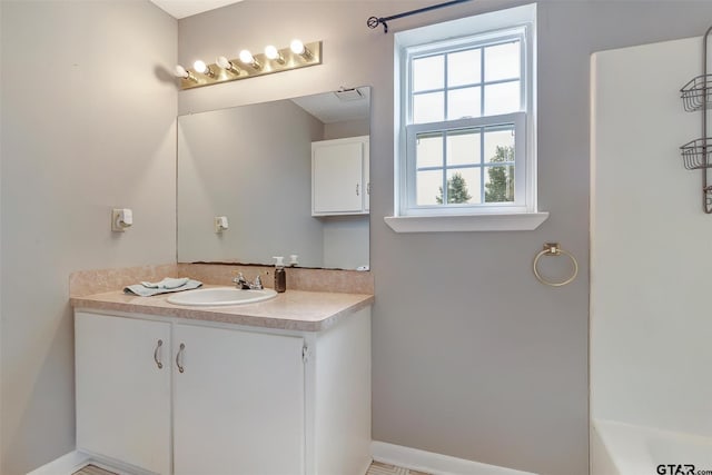 bathroom featuring vanity and a tub to relax in