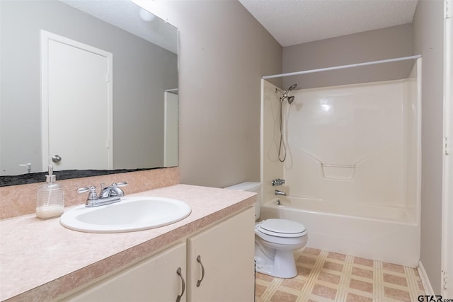 full bathroom with  shower combination, vanity, a textured ceiling, and toilet