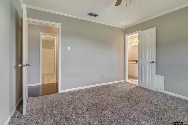 unfurnished bedroom with carpet flooring, ceiling fan, crown molding, and a textured ceiling