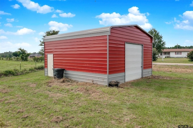 view of outbuilding with a yard and a garage