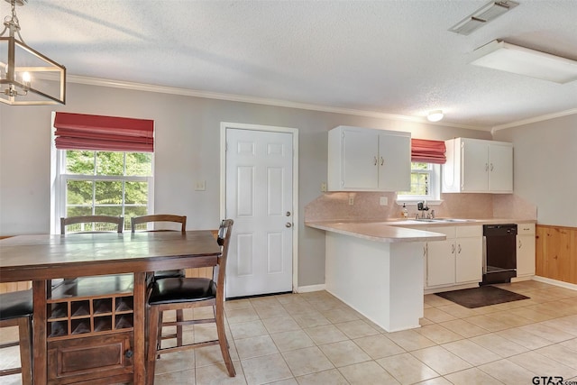 kitchen featuring white cabinets, dishwasher, decorative backsplash, and hanging light fixtures