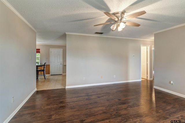 spare room with ceiling fan, crown molding, dark wood-type flooring, and a textured ceiling