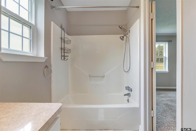 bathroom featuring vanity, shower / tub combination, and a textured ceiling