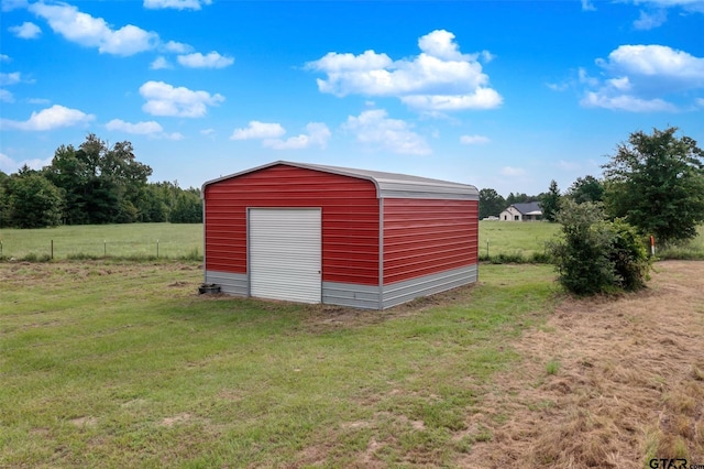 view of outdoor structure featuring a lawn and a garage