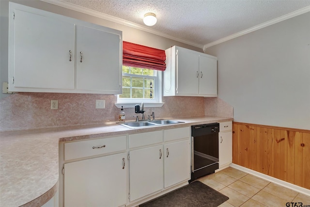 kitchen featuring backsplash, wooden walls, sink, white cabinets, and black dishwasher