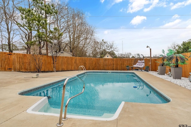 view of swimming pool with a patio, a fenced backyard, and a fenced in pool