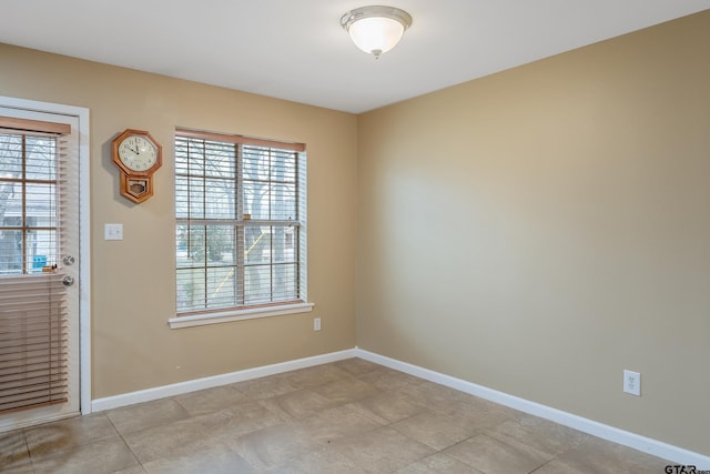 spare room with baseboards