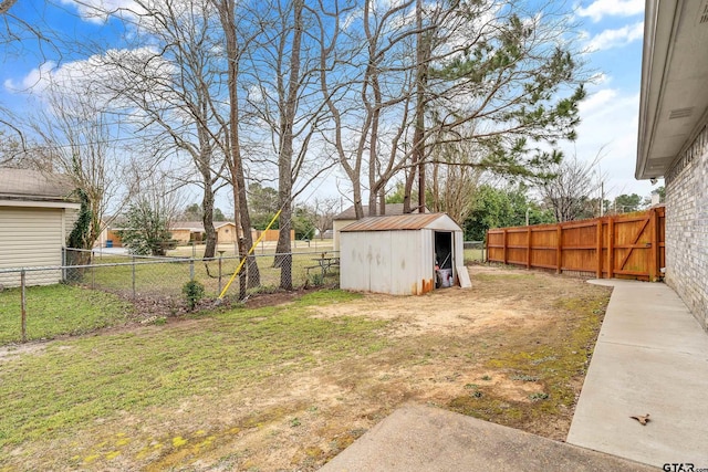 view of yard with an outbuilding, a fenced backyard, and a shed