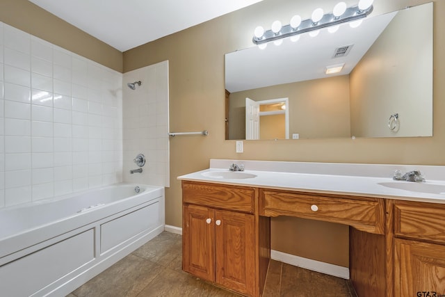 bathroom featuring double vanity, visible vents, and a sink