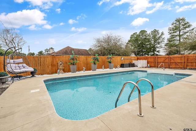 view of swimming pool with a patio, a fenced backyard, and a fenced in pool