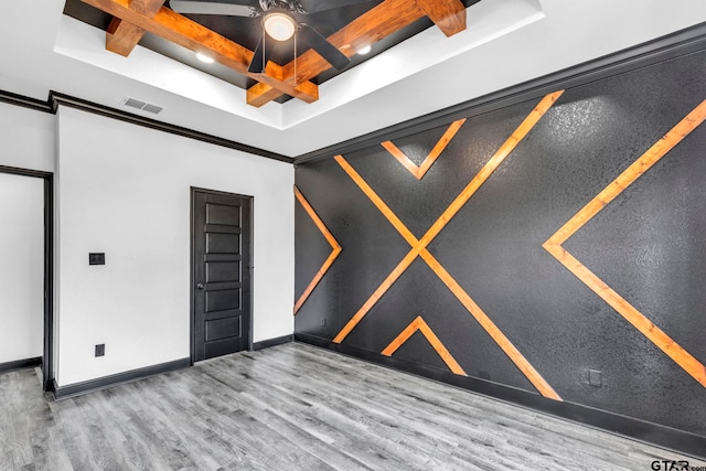 unfurnished room with visible vents, baseboards, beam ceiling, wood finished floors, and coffered ceiling