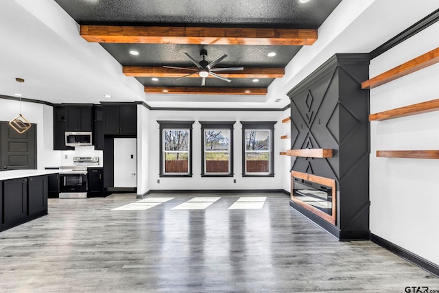 unfurnished living room featuring beam ceiling, baseboards, and light wood finished floors